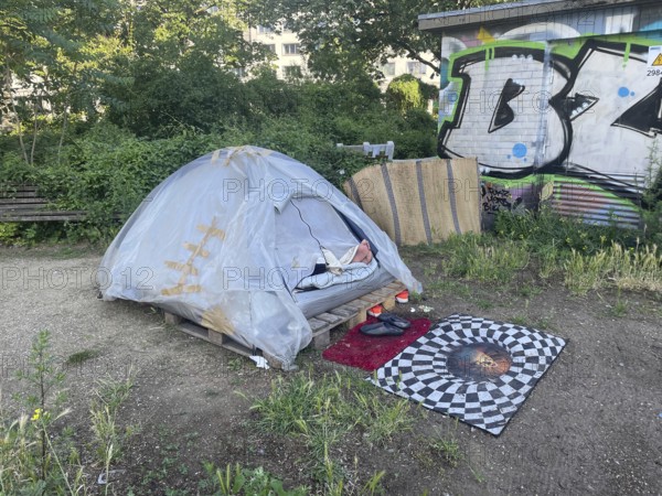 Homeless people sleeping in their tent, Yorkstrasse corner Möckernstrasse, Friedrichshain-Kreuzberg district, social issue, poverty, homelessness