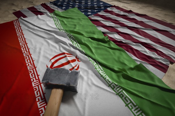 Large hammer, american and Iranian flags resting on desert sand