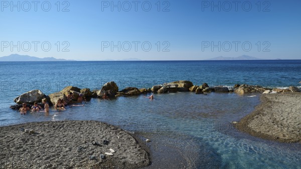 Rocks in clear blue sea, calm coastal landscape in sunshine, Embros Thermal Baths, Kos, Dodecanese, Greek Islands, Greece