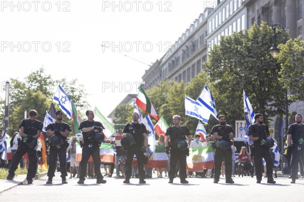 Police officers protect a pro-Israeli counter-protest with about 120 participants on the street Unter den Linden after the United 4 Gaza! Demonstration in which tens of thousands of people protested against arms deliveries from Germany and the wars in Israel-Gaza and Israel-Iran in front of the Reichstag building, Berlin, 21 June 2025