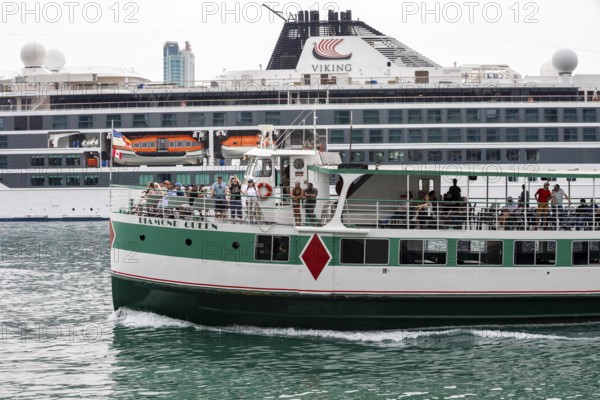 Detroit, Michigan - The sightseeing ship Diamond Queen passes the Viking Octantis luxury cruise ship in the Detroit River. The Viking Octantis had just left Detroit, heading for Lake Huron and Lake Michigan