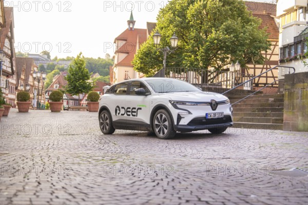 A vehicle in an urban landscape with half-timbered houses, Deer E, car sharing, electric car, Calw, Black Forest