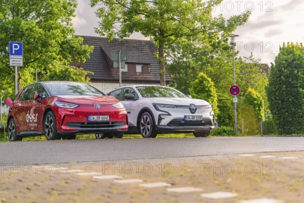 Two electric cars parked under trees in a quiet residential street, Deer E, car sharing, electric car, Calw, Black Forest