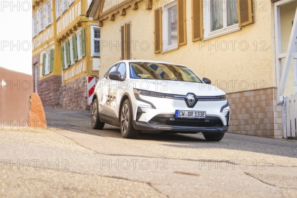 A white car on a street in a historic town with half-timbered houses, Deer E, car sharing, electric car, Calw, Black Forest