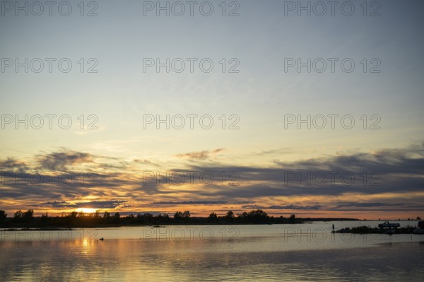 Idyllic view of the Gulf of Bothnia in the Kvarken Archipelago at sunset with calm water and colorful sky, Svedjehamn, Kvarken Archipelago, Finland