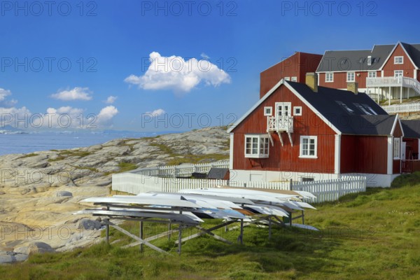 Typical architecture of Greenland Ilulissat with colored houses located near fjords and icebergs