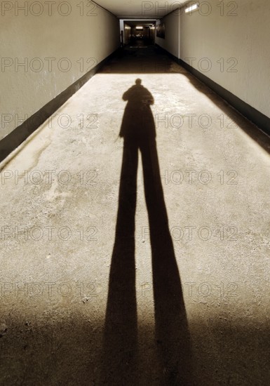 Long shadow of a person in the tunnel of the underpass to the railway tracks, train station, Bad Honnef, North Rhine-Westphalia, Germany