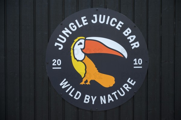 Street scene in the old town of Naantali, A jungle juice bar tropical logo with a toucan on a dark wooden background, Naanatali, Varsinais-Suomi, Finland