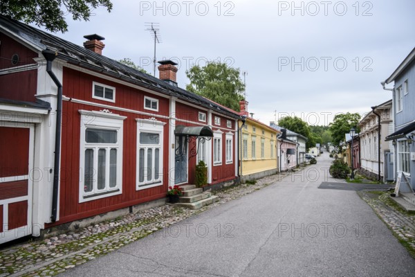 Street scene in the old town of Naantali, colorful traditional buildings on a paved, quiet street, village atmosphere, Naanatali, Varsinais-Suomi, Finland