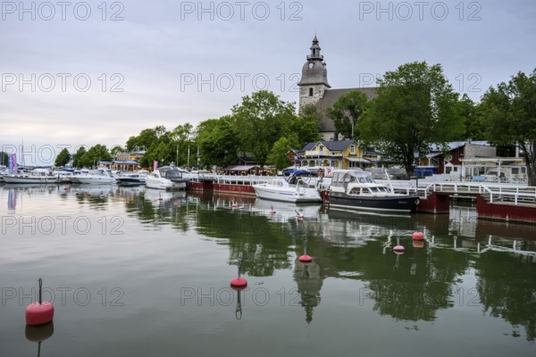 Marina Port of Naanatali with boats and a church surrounded by trees, a peaceful maritime scene, Naanatali, Varsinais-Suomi, Finland