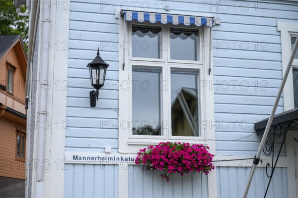 Street scene in the old town of Naantali, light blue wooden house with white windows and blooming flowers, conveys a relaxed Scandinavian ambiance, Naanatali, Varsinais-Suomi, Finland