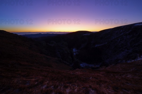 Sunrise over dark mountains with purple sky at dusk, looking towards the Rhine Valley, Martinswand, Frankental, Vosges, France