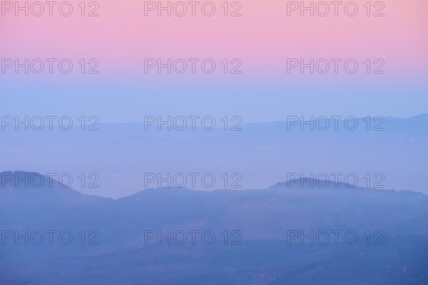 Foggy mountains spreading out under a pink sky, sunset, looking towards the Rhine Valley, Hohneck, La Bresse, Vosges, France