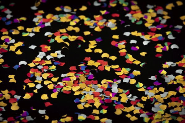 Colorful confetti on black background, carnival