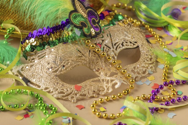Golden carnival mask, colorful beads and confetti, carnival