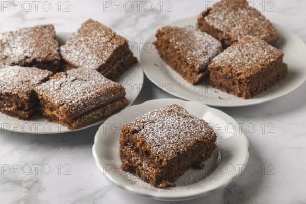 Finished cake pieces sprinkled with powdered sugar served on plates