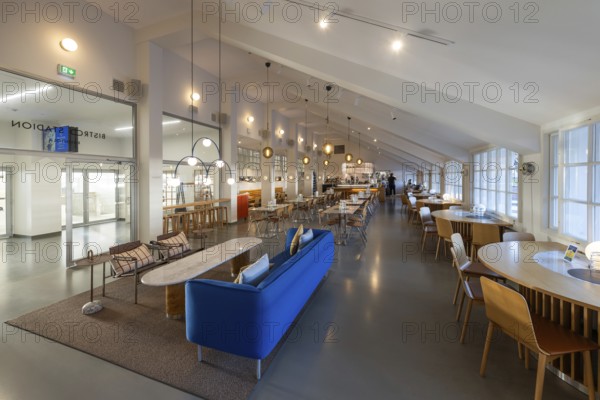 A 1950s style restaurant with seating, tables, large windows and hanging lamps, Olympic Stadium, architects Yrjö Lindegren and Toivo Jäntti, Helsinki, Finland