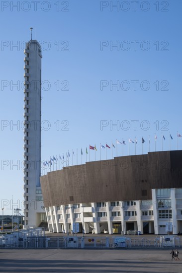 Tower with external staircase, Olympic Stadium with flags on the roof, architects Yrjö Lindegren and Toivo Jäntti, Helsinki, Finland