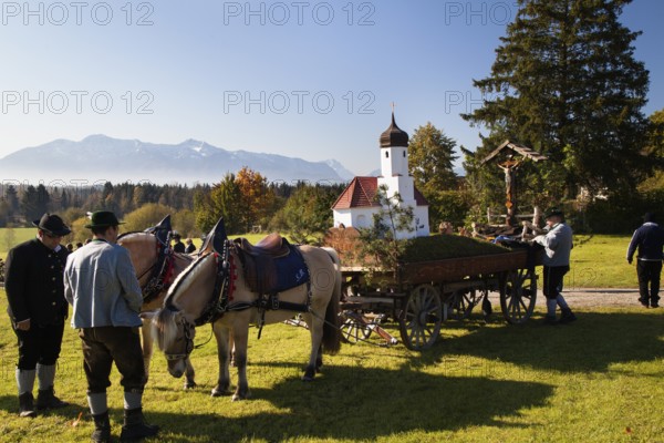 Name day move from St. Johannisrain to Penzberg on 23.10.2011 Horse wagon, church model, men in traditional costume, Upper Bavaria, Germany