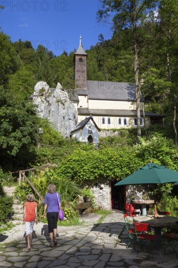 Mother and daughter in front of Maria Klobenstein pilgrimage church, Kössen, Austria