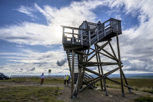 Wooden observation tower in a vast landscape under a partly cloudy sky, Kaunispää Caabuaivas, Lapland, Finland