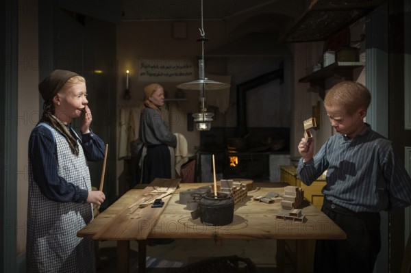 Children glue matchboxes together while working from home, child labor, historical scene recreated, Tändsticksmuseet match museum or match museum, Jönköping, Jönköpings län, Sweden
