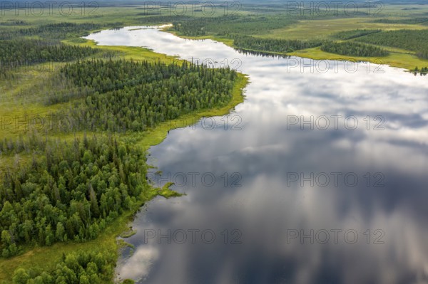 Sodankylä, Lapland, Finland, A calm river snakes through a thick forest, the clouds are reflected on the water surface, aerial view, drone shot