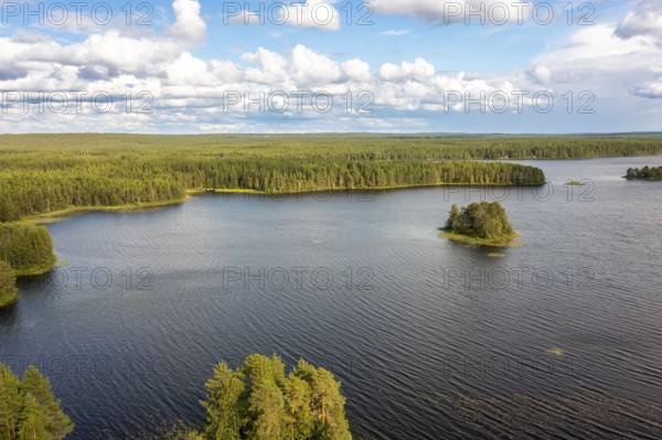 Puolanka, Kainuu, Finland, large lake with small islands and surrounding forest under a cloudy sky