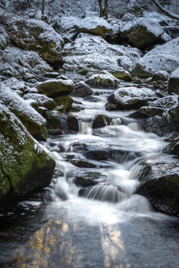 Lower Ilse Falls with snow and moss covered rocks in winter, Heinrich-Heine-Weg, Ilsetal, Harz National Park, Saxony-Anhalt, Germany