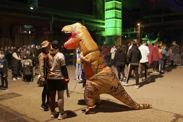 Person in inflatable dinosaur costume at Halloween Run, night run in the Duisburg-Nord Landscape Park, Duisburg, Germany, North Rhine-Westphalia, Germany