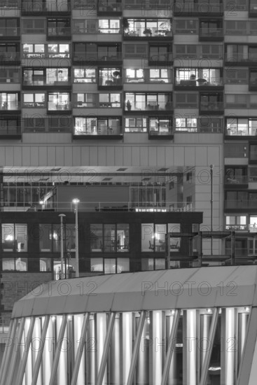 The lights of the Imhoff Chocolate Museum, behind them the illuminated façade of Kranhaus Nord, Rheinauhafen, Cologne, North Rhine-Westphalia, Germany