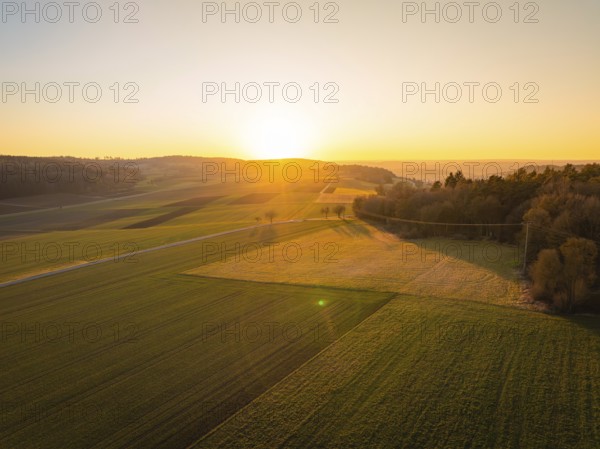 Wide landscape with fields and sunset in the background, calm atmosphere, MG4 electric car, Deer e-Carsharing, Calw, Germany