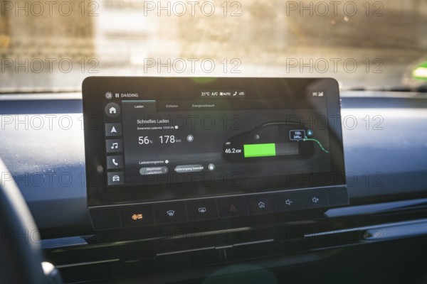 Electronic vehicle instrument shows fast charging information in modern interior, MG4 electric car, Deer e-Carsharing, Calw, Germany