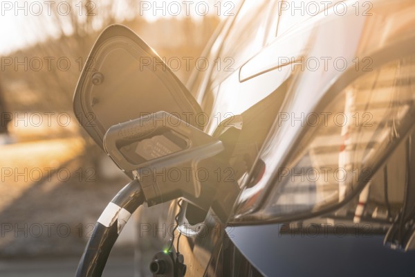 Electric car at a charging station at sunset, modern design emphasized by lighting, MG4 electric car, Deer e-Carsharing, Calw, Germany