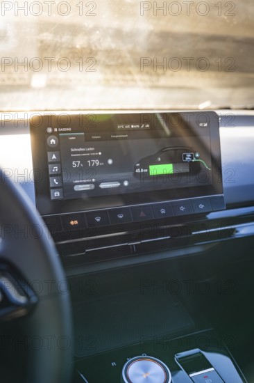 Modern car display with charging information and user interface in sunlight, MG4 electric car, Deer e-Carsharing, Calw, Germany