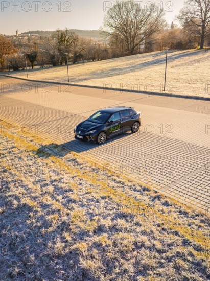 Car parked on an empty street with frosty surroundings, in early morning light, MG4 electric car, Deer E-Carsharing, Calw, Germany