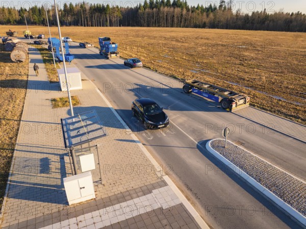 Several vehicles in a parking lot on a country road on a sunny autumn day, MG4 electric car, Deer e-Carsharing, Calw, Germany