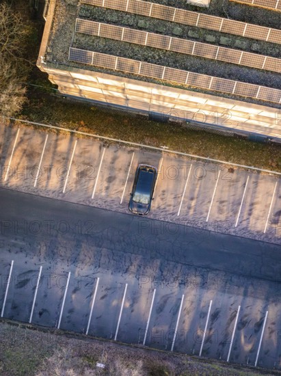 Aerial view of an empty parking lot with a single car next to a building, MG4 electric car, Deer e-Carsharing, Calw, Germany