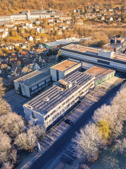 Aerial view of a large building complex surrounded by trees in an autumn landscape, MG4 electric car, Deer e-Carsharing, Calw, Germany