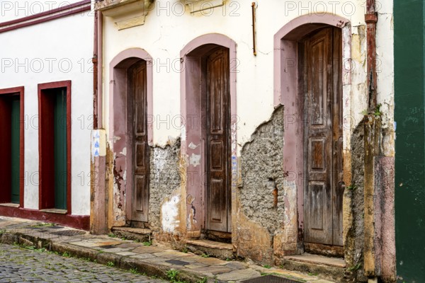 Houses in old colonial architecture with their facades worn by time in the city of Ouro Preto, Minas Gerais, Ouro Preto, Minas Gerais, Brazil