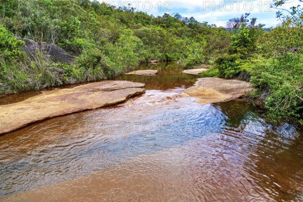 A tranquil river flowing through the forest on the outskirts of the city of Ouro Preto in Minas Gerais