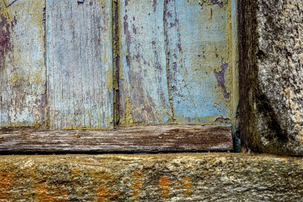 Colors and textures of an old wooden window weathered by time, in the city of Ouro Preto, Ouro Preto, Minas Gerais, Brazil