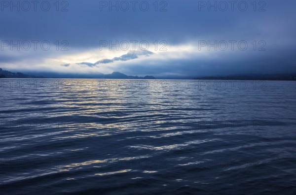 Misty morning atmosphere at the lake with Schafberg, Mondsee, Salzkammergut, Upper Austria, Austria
