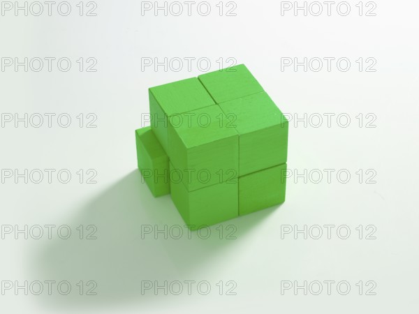 8 green wooden cubes against a white background