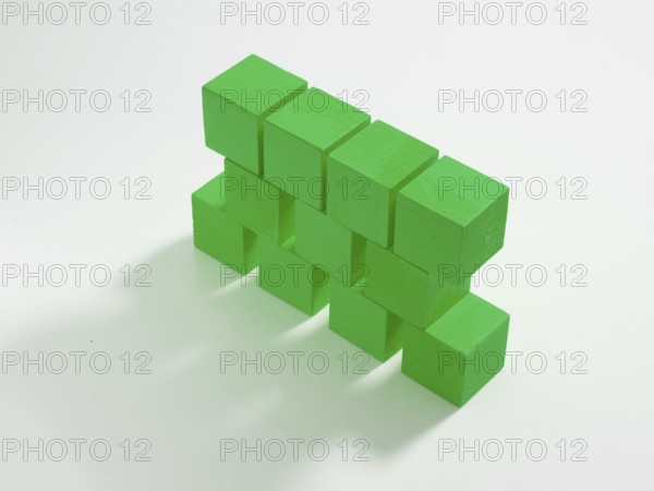 11 green wooden cubes against a white background