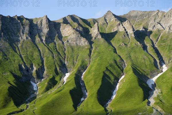 Distinctive rocky ridges with green vegetation under clear, blue air, mountain landscape between Gudauri and the Cross Pass, Mtskheta-Mtianeti region, Georgian Military Route, High Caucasus, Georgia