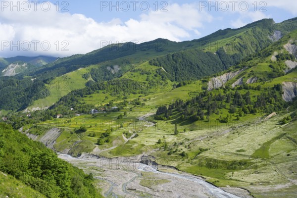 Wide green hills and a river criss-cross the mountainous landscape, landscape between Kvesheti and Gudauri, White Aragvi River, Mtskheta-Mtianeti region, Georgian Military Highway, High Caucasus, Georgia