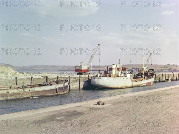 China clay industry, Ashmead cranes and cargo ship on harbour at Par, Cornwall, England, UK 1960s