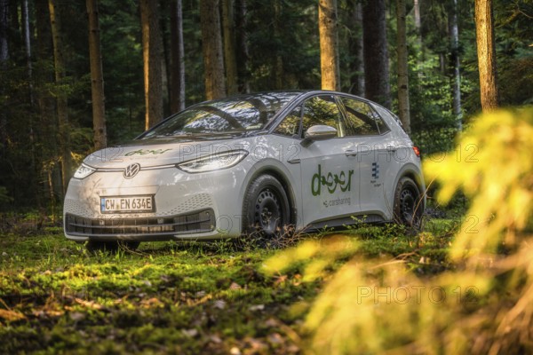 Car in the forest in natural sunlight, peaceful and green environment, VW ID3 electric car, Deer e-Carsharing, Calw, Germany