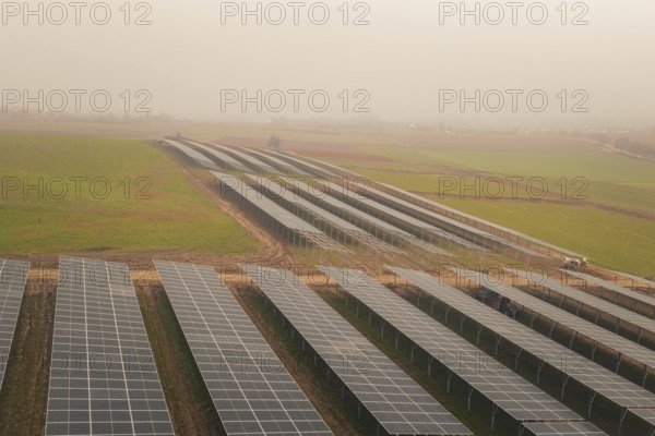 Rows of solar panels on vast green fields, focus on sustainability, energy transition, construction of PV open space, Baden-Württemberg, Germany